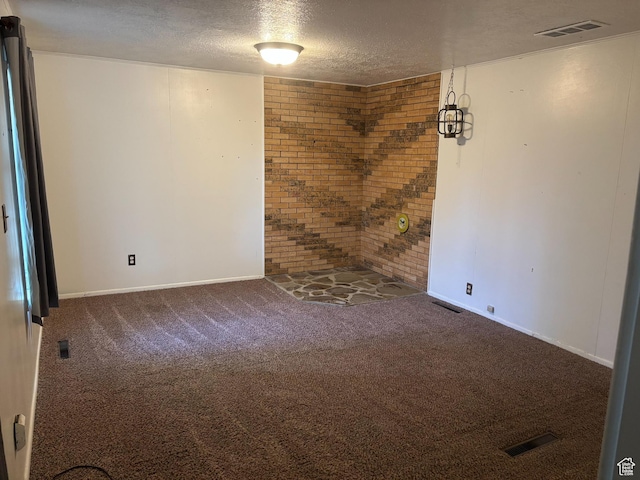 622 S Main St, Gunnison, UT 84634 - spare room with brick wall, a textured ceiling, carpet floors, and baseboards