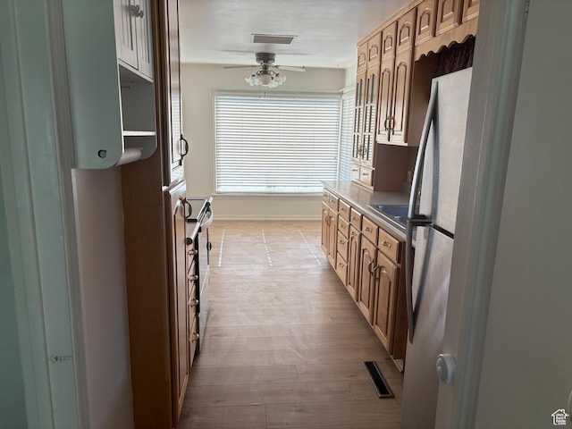 622 S Main St, Gunnison, UT 84634 - kitchen featuring ceiling fan, light wood finished floors, appliances with stainless steel finishes, and baseboards