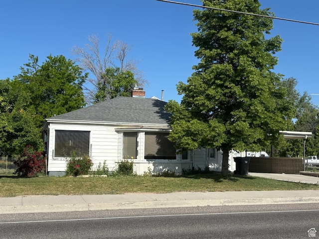 622 S Main St, Gunnison, UT 84634 - view of front of property with a chimney, roof with shingles, and a front yard