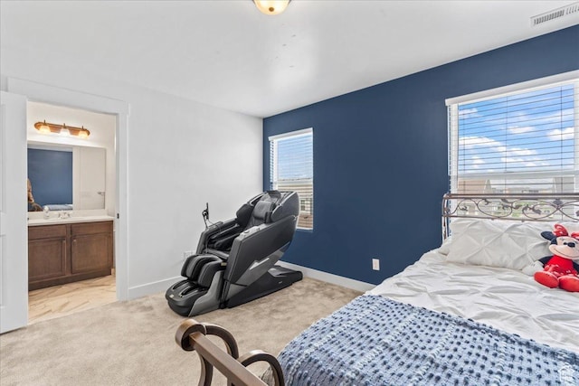 10849 S Lake Run Rd Unit 187, South Jordan, UT 84009 - bedroom with connected bathroom, baseboards, and light colored carpet