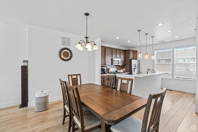 10849 S Lake Run Rd Unit 187, South Jordan, UT 84009 - dining space featuring light wood-style flooring, baseboards, a chandelier, and recessed lighting