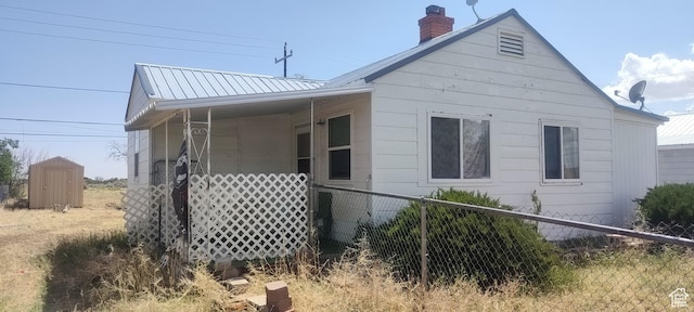 138 W Geneva Dr, East Carbon, UT 84520 - view of home's exterior with a chimney and metal roof