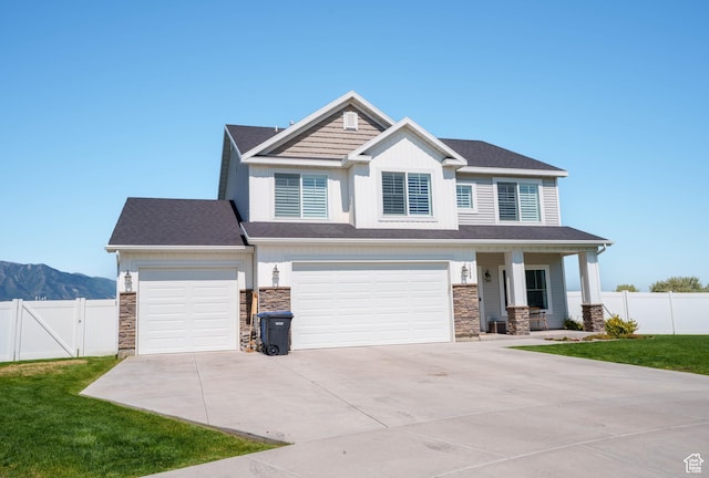 1389 W 2870 S, Nibley, UT 84321 - craftsman inspired home with driveway, stone siding, a mountain view, and an attached garage