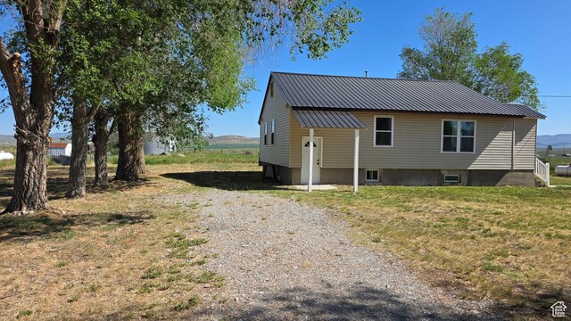 20915 W 1300 S, Malad City, ID 83252 - rear view of house featuring gravel driveway and metal roof
