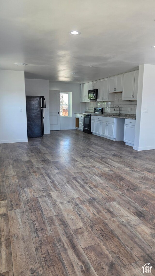20915 W 1300 S, Malad City, ID 83252 - unfurnished living room with dark wood-style flooring, baseboards, a sink, and recessed lighting