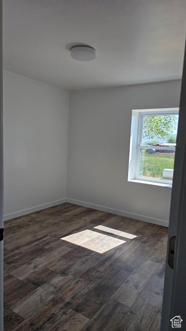 20915 W 1300 S, Malad City, ID 83252 - spare room featuring dark wood-style flooring and baseboards