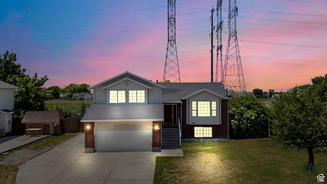 4683 S 3200 W, Roy, UT 84067 - tri-level home with brick siding, an attached garage, a front lawn, driveway, and roof with shingles