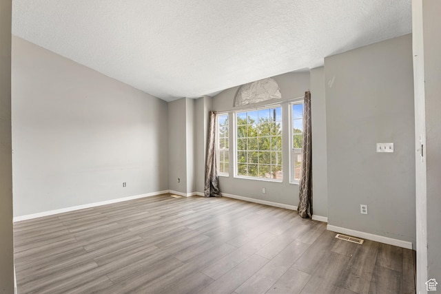 4683 S 3200 W, Roy, UT 84067 - empty room with wood finished floors, a textured ceiling, and baseboards