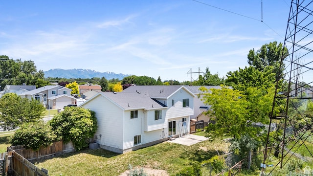 4683 S 3200 W, Roy, UT 84067 - back of property featuring a mountain view, a residential view, a patio, and central air condition unit