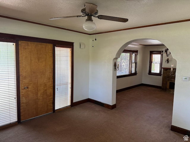 67 S 200 E, Pleasant Grove, UT 84062 - carpeted empty room with arched walkways, ceiling fan, baseboards, ornamental molding, and a textured ceiling