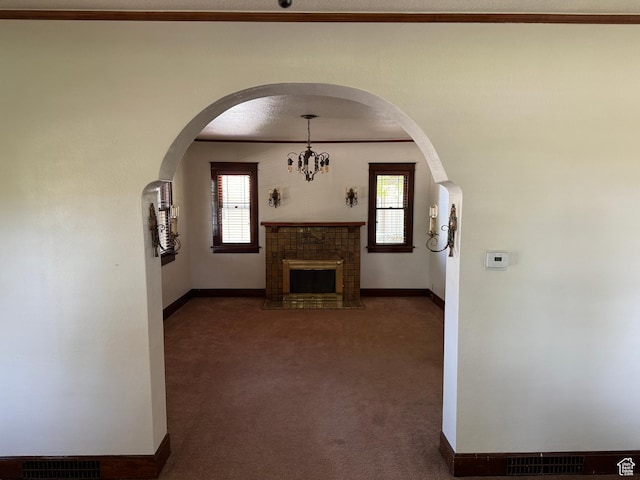 67 S 200 E, Pleasant Grove, UT 84062 - unfurnished living room with baseboards, a fireplace with flush hearth, carpet floors, ornamental molding, and a chandelier