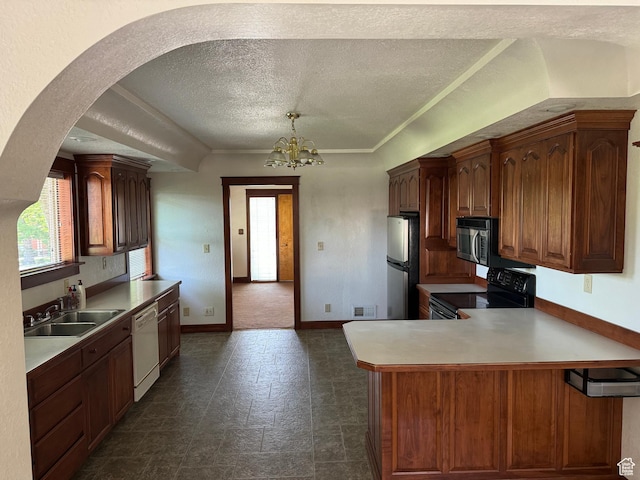67 S 200 E, Pleasant Grove, UT 84062 - kitchen featuring stainless steel appliances, a sink, a textured ceiling, arched walkways, and a peninsula