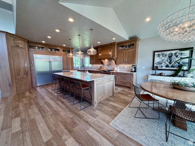1820 S Kerrybrook Dr, Kaysville, UT 84037 - kitchen with high end appliances, premium range hood, light countertops, a breakfast bar, and recessed lighting