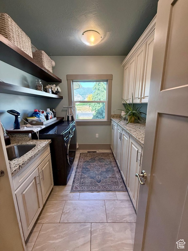 1820 S Kerrybrook Dr, Kaysville, UT 84037 - washroom with cabinet space, washing machine and dryer, a textured ceiling, and baseboards
