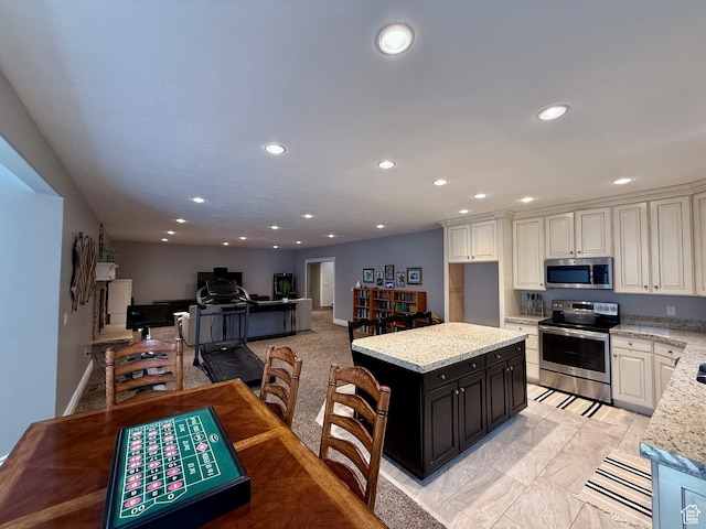 1820 S Kerrybrook Dr, Kaysville, UT 84037 - kitchen featuring appliances with stainless steel finishes, recessed lighting, a center island, light stone countertops, and white cabinets