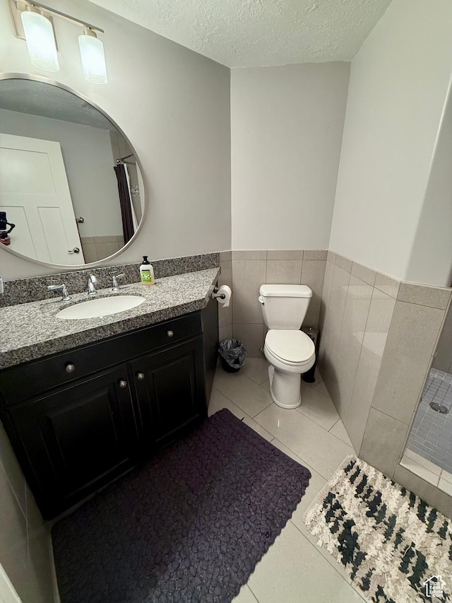1820 S Kerrybrook Dr, Kaysville, UT 84037 - bathroom featuring toilet, a wainscoted wall, a textured ceiling, vanity, and tile patterned floors