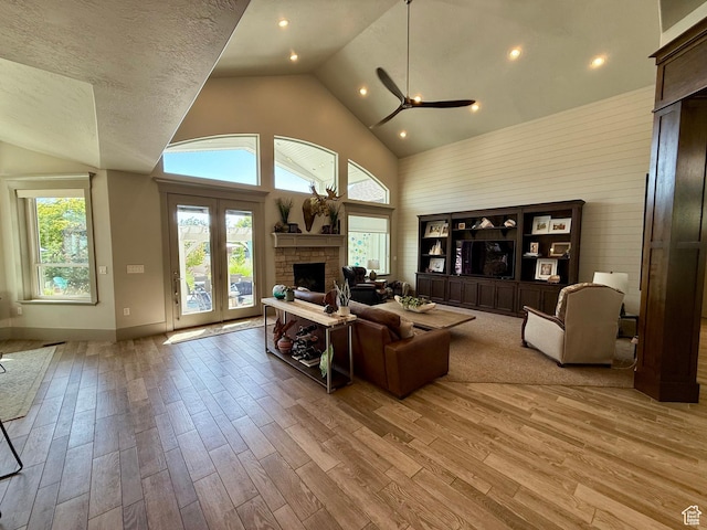 1820 S Kerrybrook Dr, Kaysville, UT 84037 - living area featuring a fireplace, light wood-type flooring, plenty of natural light, and high vaulted ceiling