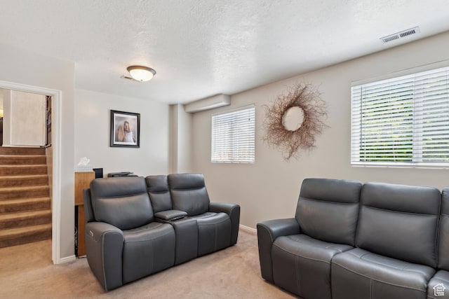 4293 W 5550 S, Roy, UT 84067 - living area with light carpet, stairway, a textured ceiling, and baseboards