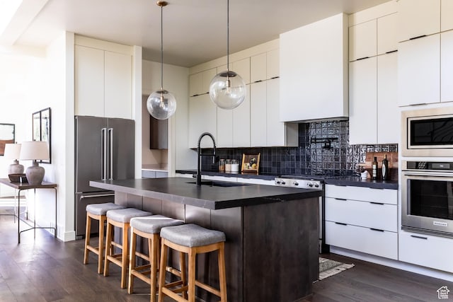 10727 N Dosh Ln, Highland, UT 84003 - kitchen with stainless steel appliances, modern cabinets, dark countertops, and a sink