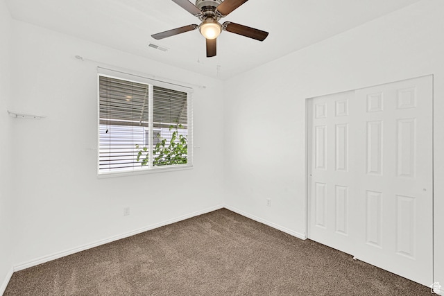282 Caleb Dr, North Salt Lake, UT 84054 - unfurnished bedroom with dark colored carpet, baseboards, and ceiling fan