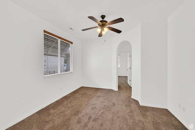 282 Caleb Dr, North Salt Lake, UT 84054 - carpeted spare room with arched walkways, a ceiling fan, and baseboards
