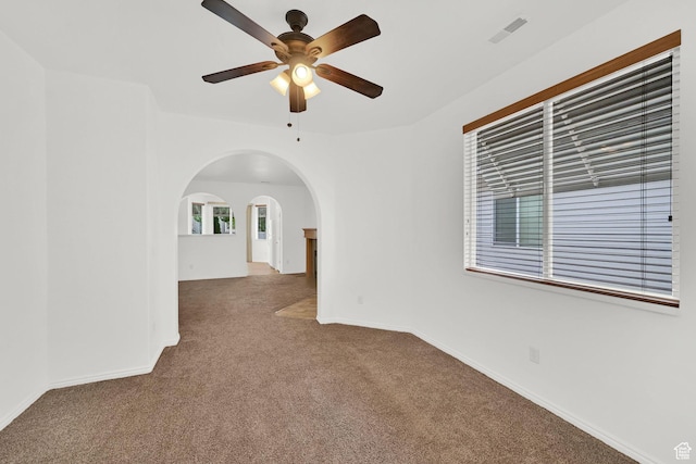 282 Caleb Dr, North Salt Lake, UT 84054 - spare room featuring carpet, arched walkways, a ceiling fan, and baseboards