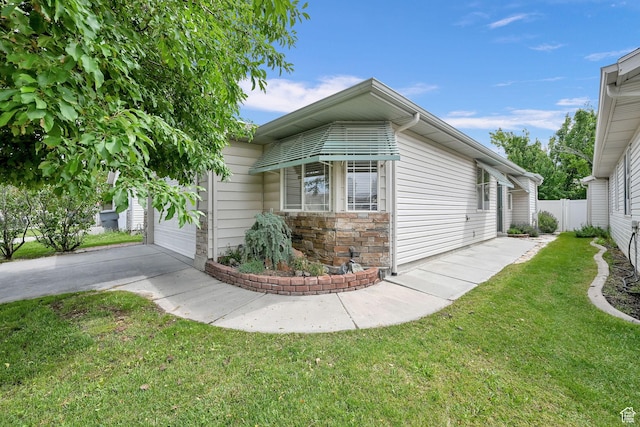 282 Caleb Dr, North Salt Lake, UT 84054 - view of side of home featuring driveway, an attached garage, and stone siding