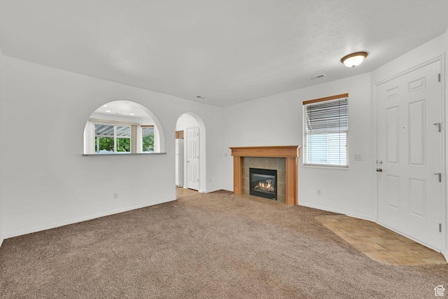 282 Caleb Dr, North Salt Lake, UT 84054 - unfurnished living room with healthy amount of natural light, carpet flooring, baseboards, and a fireplace