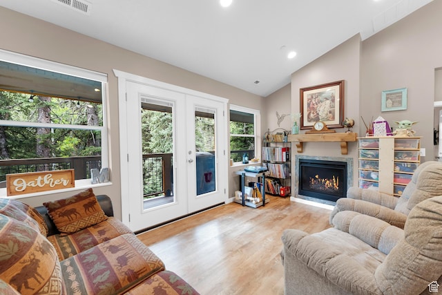 11316 E Silver Fork Rd, Brighton, UT 84121 - living area with vaulted ceiling, wood finished floors, a lit fireplace, recessed lighting, and french doors