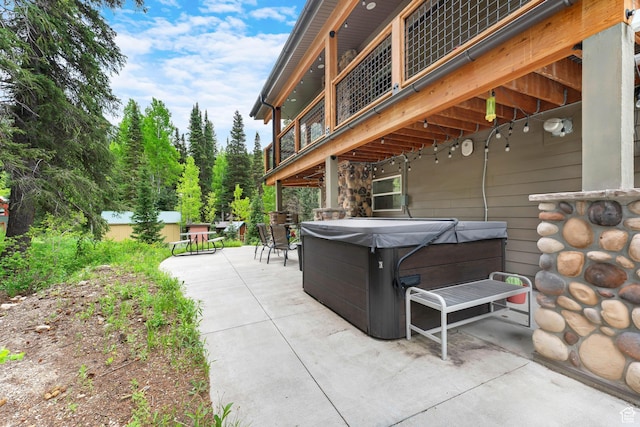 11316 E Silver Fork Rd, Brighton, UT 84121 - view of patio with a hot tub, a balcony, and outdoor dining space