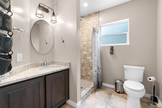 11316 E Silver Fork Rd, Brighton, UT 84121 - full bath featuring vanity, toilet, a stall shower, baseboards, and tile patterned flooring
