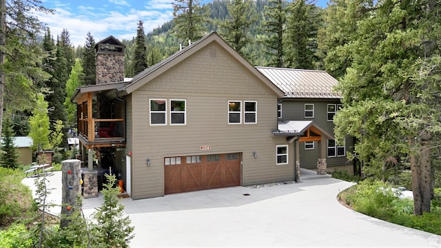 11316 E Silver Fork Rd, Brighton, UT 84121 - view of front of home featuring driveway, a chimney, and an attached garage