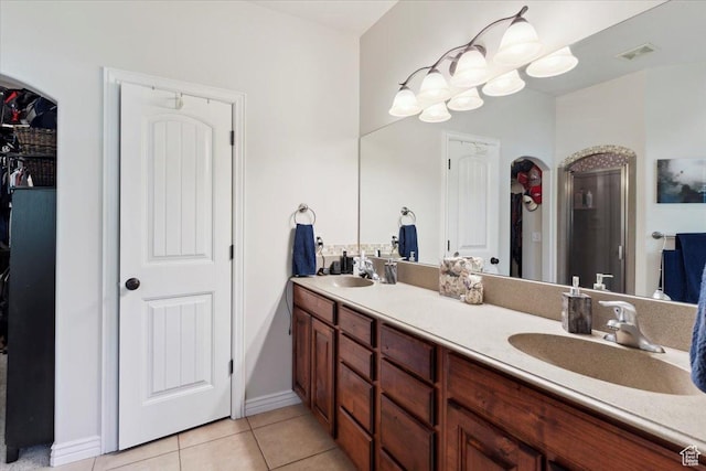 969 S View Crest Ln W, Kaysville, UT 84037 - bathroom with double vanity, tile patterned flooring, a walk in closet, and baseboards
