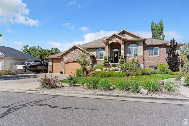 969 S View Crest Ln W, Kaysville, UT 84037 - view of front of property featuring a garage, driveway, and stone siding