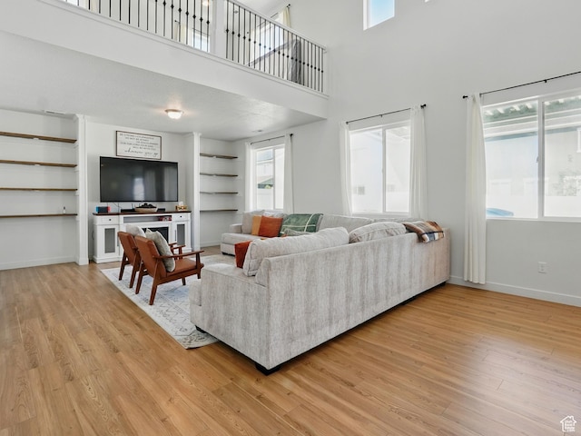 3287 S Boots Way, Syracuse, UT 84075 - living area with light wood finished floors, healthy amount of natural light, built in shelves, baseboards, and a high ceiling