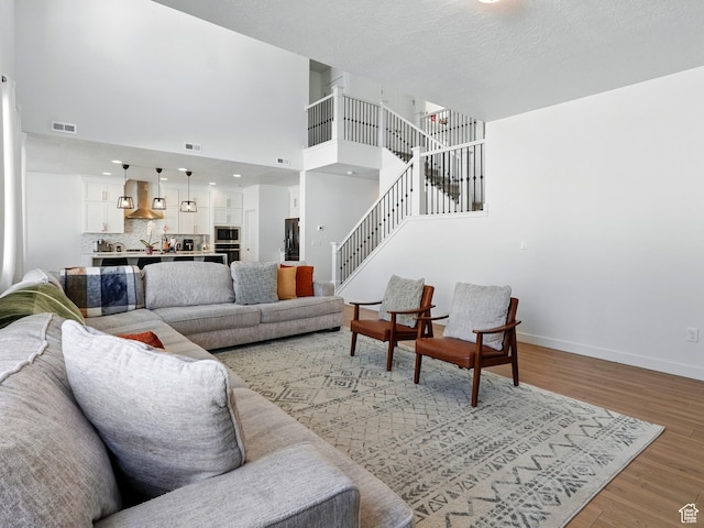 3287 S Boots Way, Syracuse, UT 84075 - living room with light wood finished floors, stairway, and baseboards