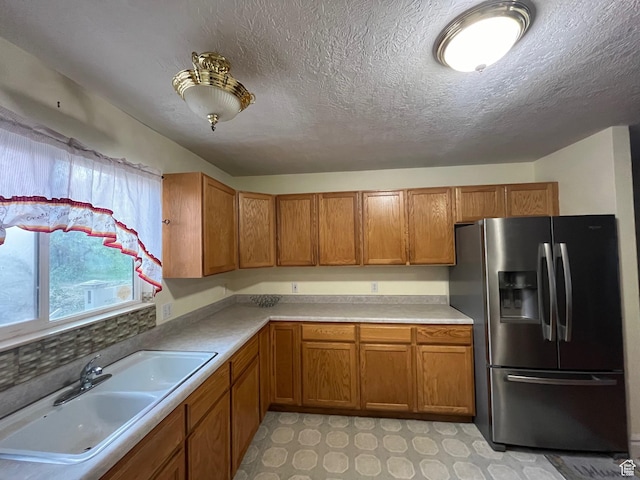 632 W 200 N, Salt Lake City, UT 84116 - kitchen with stainless steel fridge with ice dispenser, brown cabinetry, a sink, light countertops, and a textured ceiling