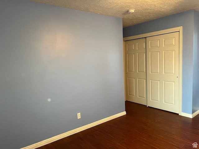 632 W 200 N, Salt Lake City, UT 84116 - unfurnished bedroom with dark wood finished floors, a textured ceiling, and a closet
