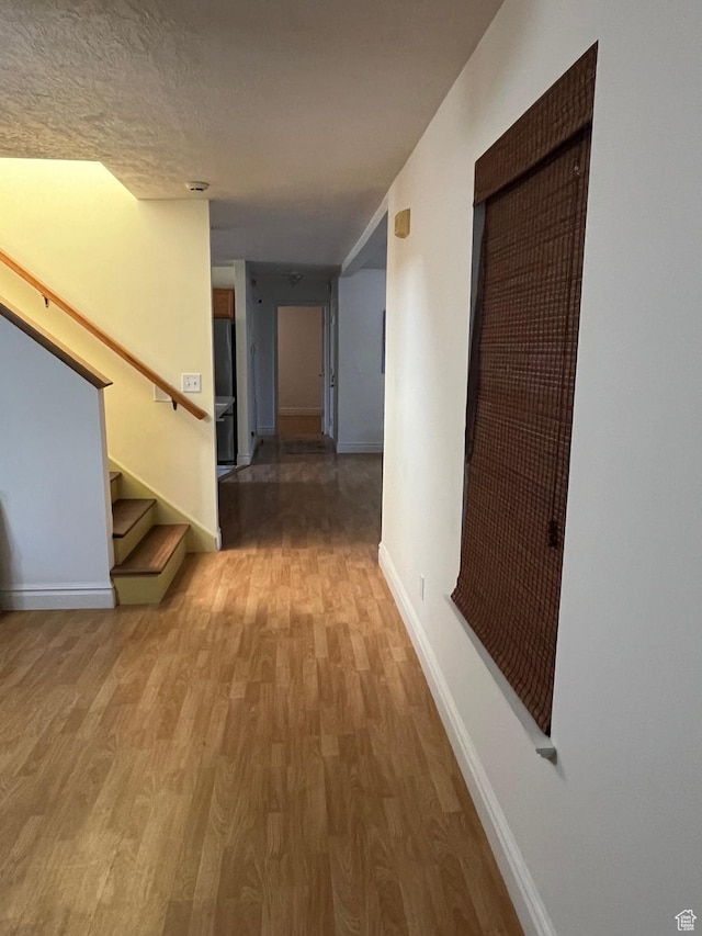 632 W 200 N, Salt Lake City, UT 84116 - hall featuring light wood finished floors, stairway, and a textured ceiling