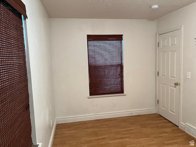 632 W 200 N, Salt Lake City, UT 84116 - unfurnished bedroom with light wood-style floors and a textured ceiling