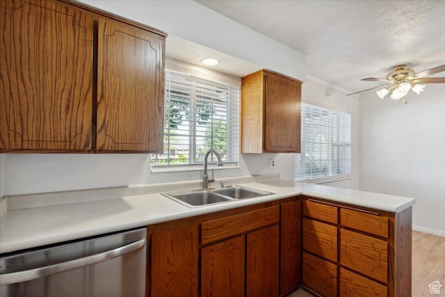 920 N 200 W, Bountiful, UT 84010 - kitchen with stainless steel dishwasher, a sink, a peninsula, light countertops, and brown cabinets