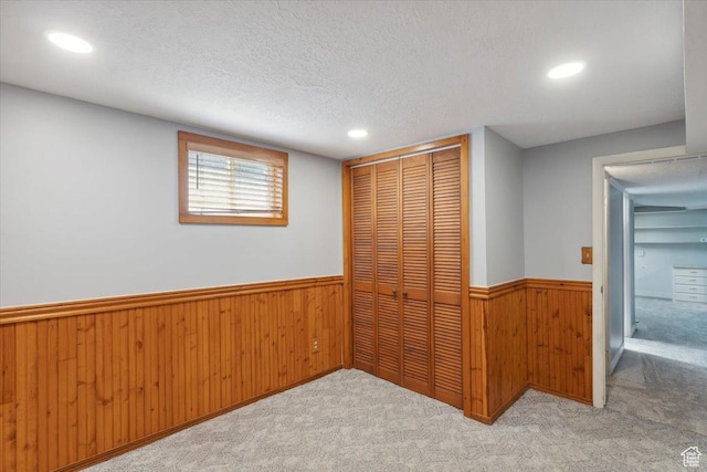 920 N 200 W, Bountiful, UT 84010 - unfurnished bedroom with wainscoting, a closet, carpet, wood walls, and a textured ceiling