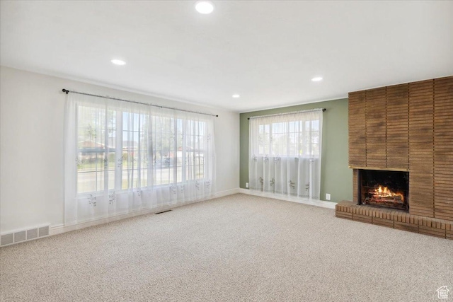 920 N 200 W, Bountiful, UT 84010 - unfurnished living room with carpet flooring, recessed lighting, a fireplace, and plenty of natural light