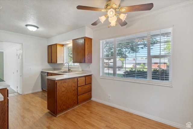 920 N 200 W, Bountiful, UT 84010 - kitchen featuring stainless steel dishwasher, a sink, brown cabinets, a peninsula, and plenty of natural light