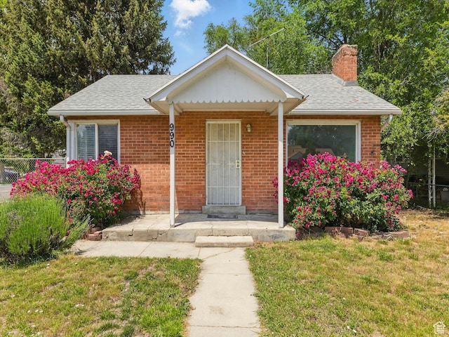 990 W 300 N, Provo, UT 84601 - view of front of house with a chimney, brick siding, and a shingled roof