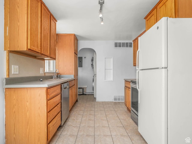 990 W 300 N, Provo, UT 84601 - kitchen with stainless steel appliances, arched walkways, light tile patterned floors, a sink, and estacked washer and dryer
