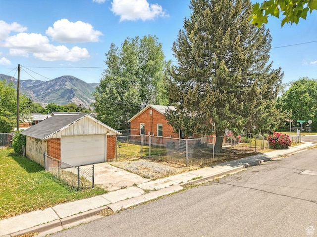 990 W 300 N, Provo, UT 84601 - view of front of property featuring brick siding, a mountain view, a detached garage, and an outbuilding