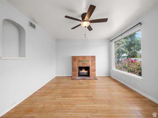 990 W 300 N, Provo, UT 84601 - unfurnished living room featuring a ceiling fan, light wood finished floors, a tiled fireplace, and baseboards