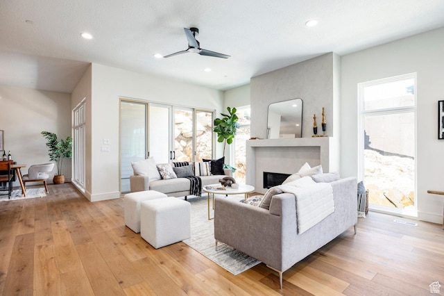 4107 W Crest Ct, Park City, UT 84098 - living room with light wood-type flooring, ceiling fan, a glass covered fireplace, baseboards, and recessed lighting