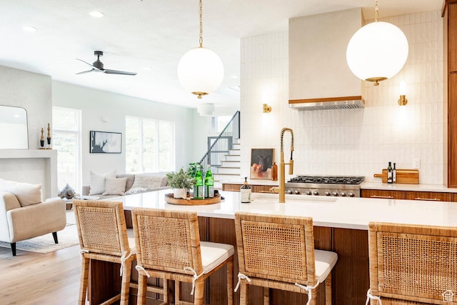 4107 W Crest Ct, Park City, UT 84098 - kitchen with light countertops, tasteful backsplash, open floor plan, decorative light fixtures, and recessed lighting